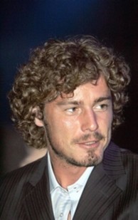 Marat Safin with long curly hairstyle with big curls and side bangs
