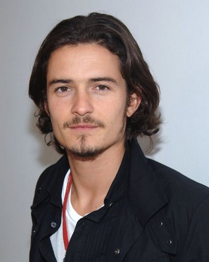 Orlando Bloom with medium wavy hairstyle with long side bang.jpg