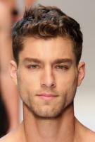 2015 wavy short man's haircut with thick volume on the top middle and short hair on the sides.JPG