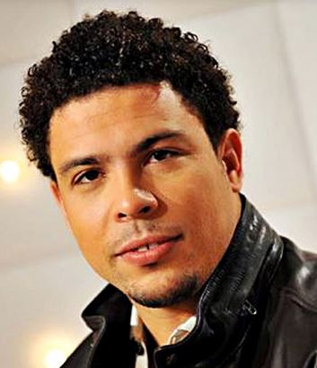 Classic black mans hairstyle with natural African curls.JPG