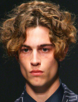 2013 man curly haircut with big wavy curls with very long side bangs and very short in the back.PNG