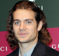 Cavill Henry with long curly hairstyle and long pulled back bangs.PNG
