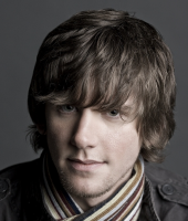 2013 men medium haircuts with layers and very long layered bangs that give and messy chic look for young men.PNG