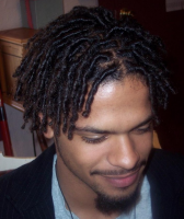 Black men hairstyle with tight curls and medium long hair length with very long side bangs.PNG