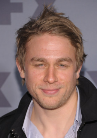 Charlie Hunnam actor with his medium hairstyle and spiky top and layered bangs

