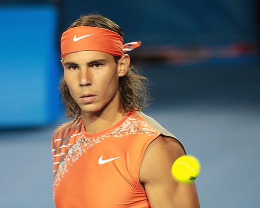 Rafael Nadal hairstyle with head band during his tennis game.jpg
