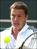 Marat Safin on tennis court with his very short hair cut