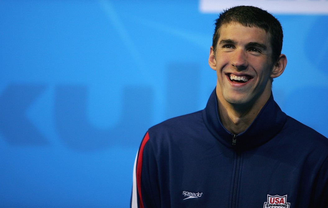 Michael Phelps smiling brightly with his short wet hair.jpg