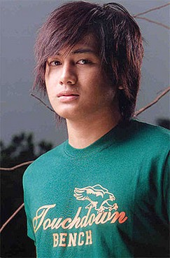 Cute looking Asian man with layered hairstyle and long side bangs in medium long hair length
