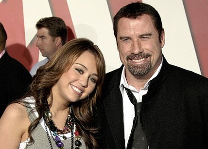 Miley Cyrus and John Travolta with his very short hair cut.jpg