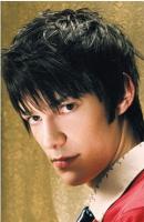 Men short layered haircut with long bang black hair with trendy look.JPG