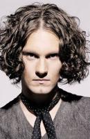 Man medium long curly hairstyle with long side bangs in dark brown hair color.JPG