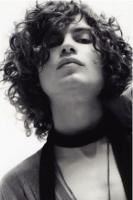 Man long curly hairstyle with very long curly bangs looking very trendy and fashion.JPG