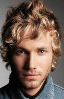 Man long medium curly and wavy haircut in blonde and light brown and side bangs.JPG
