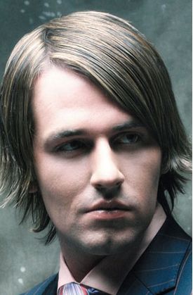Men medium hairstyle with layers on the end and long side bangs.JPG
