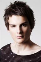 Brunette man medium haircut with full of layers  and funky bang