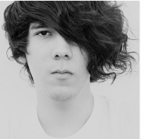 Awesome photo of a young man with long wavy hairstyle and a funky bang swept on one side.PNG